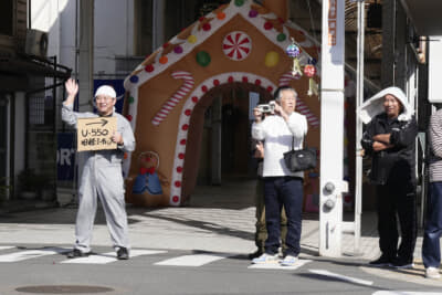 イオンタウン川之江から会場へと向かう参加者を、商店街入り口で誘導するスタッフとギャラリーの皆さん