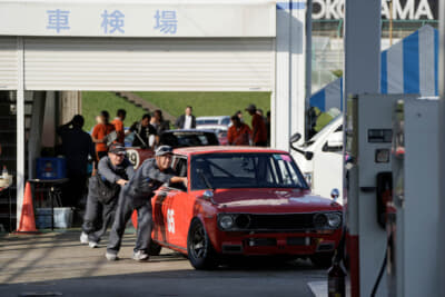 レース前日の車検を無事にクリアし、マシンを押し運ぶ下平選手（手前）と、AE86レース時代のライバルであり友人の松下さん