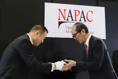 中嶋 敬一郎NAPAC会長からトロフィーを授与される株式会社交通タイムス社 宮木敏也代表取締役
