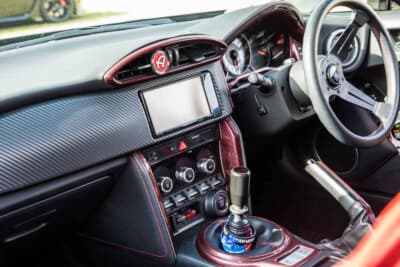 トヨタ 86：シートはオリジナルのままだが、GTリミテッドの赤いアクセントに合わせて、ダッシュ周りのパネルをレッドカーボンを採用している
