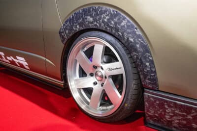 トヨタ ハイエース：リアホイールアーチ周辺のカーボンオーバーフェンダーの仕上がり。マットブロンズのボディとマーブルカーボンのコントラストが、欧州プレミアムカーを彷彿させる