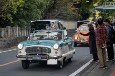 コマ図を頼りに周遊するツーリングへと出発するAMC メトロポリタン。ナビは物心ついた時からクルマ好きという息子さんが担当し、沿道の観客が見守るなか約2時間のドライブへと向かった