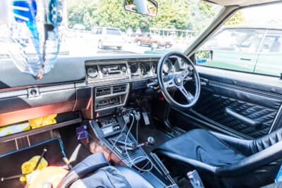 日産 バイオレット・オースター 1400DX：スポーツステアリング、4速MTシフトノブを備えた室内。ラリー仕様へのカスタムはインテリアにも及んでいる