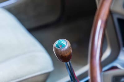 トヨタ クラウンハードトップ：5速の変速パターンが刻まれたグリーン地の天板を持つ木製シフトノブ。マニュアル仕様ならではのこだわりが詰まる