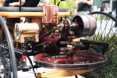 メルセデス・ベンツ パテントモトールヴァーゲン（1886年）：後方の巨大な円盤がフライホイールだ。954cc・水冷水平単気筒エンジンが発生させる0.75hpという極小のトルクを回転エネルギーとして蓄え、400rpmという低回転域でも脈動なく走り続けられる仕組みになっている