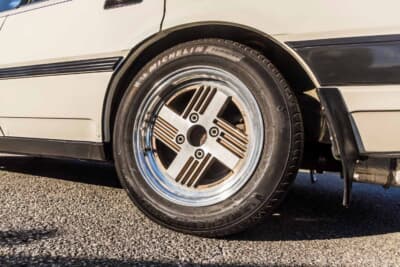 日産 レパード：4本スポークデザインの純正アルミホイールをクローズアップ。ミシュランの現代タイヤを組み合わせ、足元の実用性とオリジナルの雰囲気を両立させている